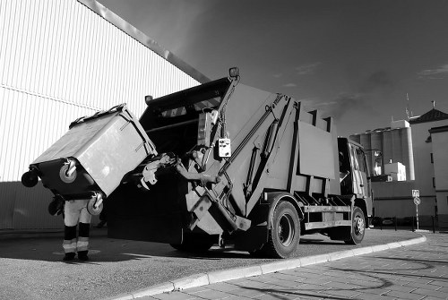 Company vehicle and skip on site during delivery for skip hire operations